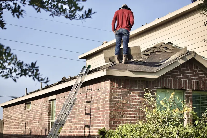 Professional roofer working on a residential roof in Hempfield